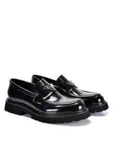 Side view of premium men's black glossy patent leather loafers with chunky lug soles.