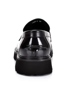 Detailed rear view of black shiny platform loafer showing heel stitching and thick sole