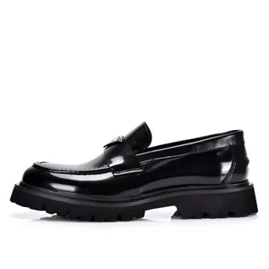 Black patent leather men's loafers with thick platform lug soles in a sleek design.