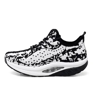 Side detail of black and white knit women's rocking shoes with thick air-cushion sole.
