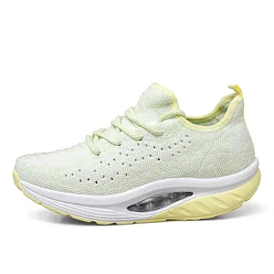 Side view showing breathable mesh upper and thick rocker sole of women's lime green sneaker