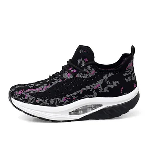 Side view of women's black fly-knit rocking sneakers with pink accents and air cushion