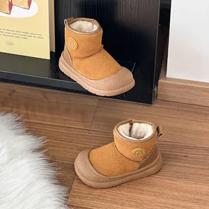 Detail view of camel fleece-lined kids' snow boots with soft rubber soles for winter