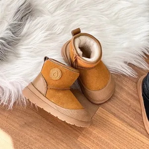 Detailed view of the warm plush lining and side zipper on kids' tan winter snow boots