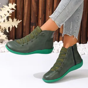 Detail view of green women's casual ankle boots with side zipper and elastic laces