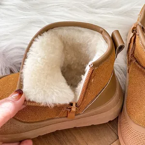 Close-up of kids' winter boot showing thick faux fur lining and functional side zipper.