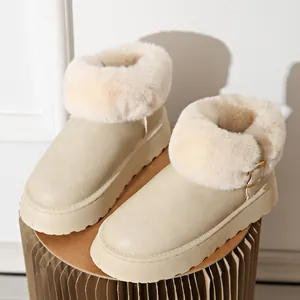 Detail view of beige winter snow boots with thick platform soles and faux fur trim