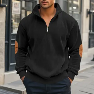Detailaufnahme des schwarzen Cord-Pullovers mit halbem Reißverschluss und Ellbogen-Patches.