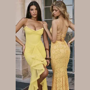 Detailed view of sexy yellow backless mesh dresses on models in a classic setting.