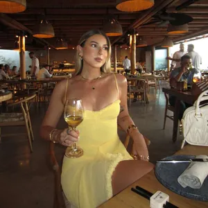 Elegant sexy yellow mesh backless maxi dress for women in a lifestyle restaurant