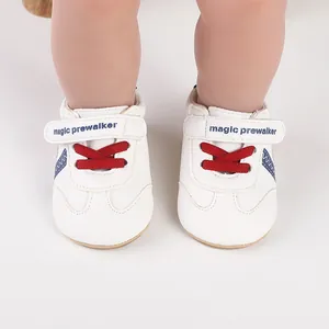 Nahaufnahme von weißen Baby-Lauflernschuhen mit roten Schnürsenkeln und blauen Akzenten.