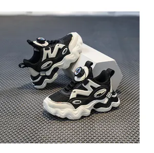 Primo piano di sneakers chunky per bambini in bianco e nero con chiusura rotante.