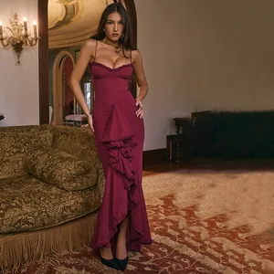 Elegant burgundy backless mesh maxi dress with ruffled detailing shown in a vintage interior.