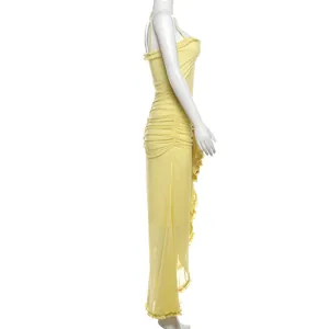 Side view detail of a yellow mesh camisole maxi dress with ruffles and ruched design