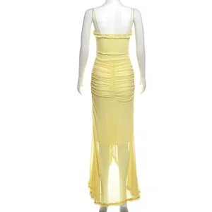 Back view of yellow ruched mesh maxi dress with thin spaghetti straps