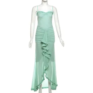 Detail view of mint green mesh maxi dress with ruched bodice and ruffled front slit