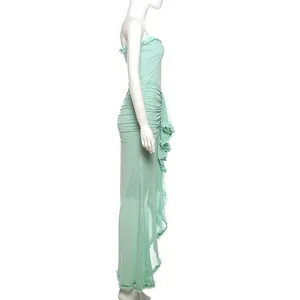 Side view of a slim-fit mint green mesh camisole maxi dress with ruffled details