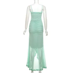 Detail view of mint green mesh strap long dress showing ruched back and sheer hem.