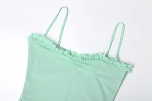 Close-up of mint green mesh camisole dress featuring elegant ruffled neckline detail
