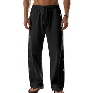 Vue détaillée de la taille à cordon et des boutons latéraux sur le pantalon en lin noir