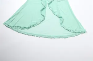 Macro view of the delicate ruffled hem on this mint green mesh evening long dress