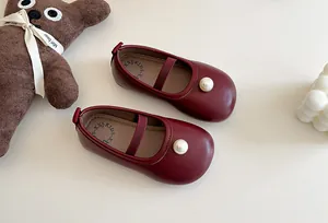Detailed view of burgundy girls Mary Jane shoes featuring elegant pearl embellishment