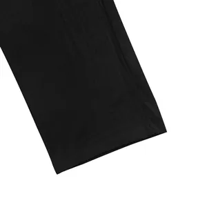 Close-up detail of the black breathable linen fabric and hem on men's casual pants