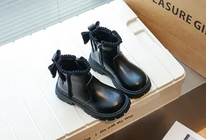 Détail de bottines Martin noires pour enfants avec nœud mignon et fermeture éclair