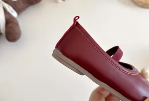 Detailed view of burgundy girls' Mary Jane shoes with soft sole and heel pull-tab