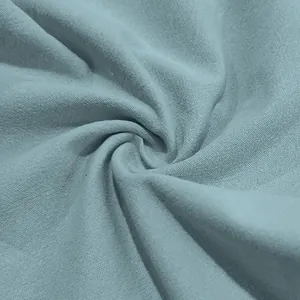Detailed macro view of light blue breathable linen fabric texture for men's casual pants