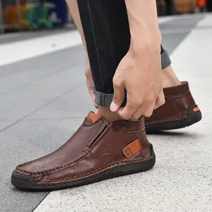 Detailed view of brown high-top leather loafers featuring hand-stitched moccasin seams