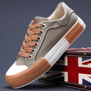 Stylish men's low-top khaki canvas sneakers with brown laces and thick white rubber sole.