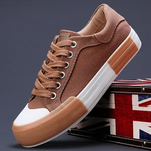 Fashionable brown low-top men's canvas sneakers featuring durable rubber sole for daily wear