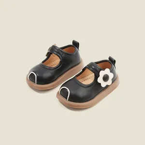 Elegant black leather toddler shoes with flower detail and comfortable thick soles