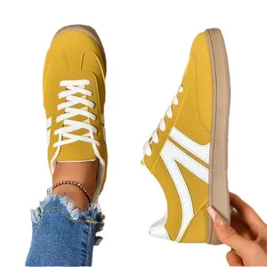 Yellow retro women's sneakers, lace-up round toe flat skate shoes on white background