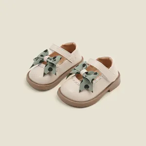 Beige baby girl Mary Jane shoes with green polka dot bow decoration