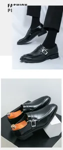 Close-up detail of black leather monk strap shoes with silver buckle and wooden shoe trees.