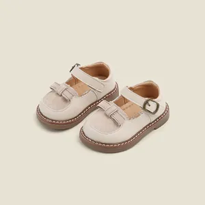 Elegant beige baby princess walking shoes with soft rubber soles and bow decoration