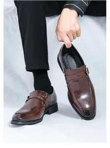 Detailed shot of a brown leather monk strap loafer showcasing its elegant glossy finish