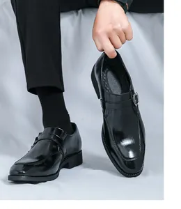 Detailed shot of black men's business casual monk strap shoes with a shiny leather finish