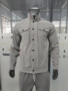 Men's gray corduroy jacket with chest pockets and black button closure on mannequin