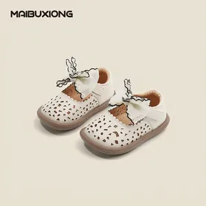 Cream-colored baby girl princess shoes with large lace bow and hollowed-out details