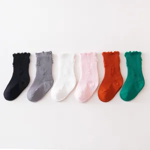Distressed children's crew socks with ruffled tops in six vibrant solid colors