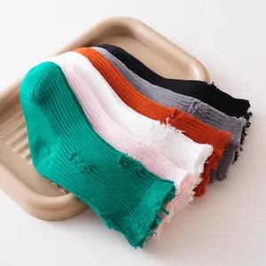 Detailed macro view of colorful distressed cotton children's socks with ribbed texture