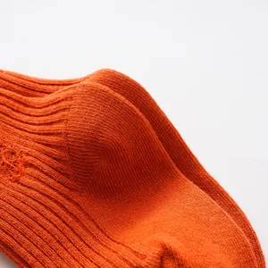 High-resolution macro view of bright orange ribbed texture on fashion kids socks
