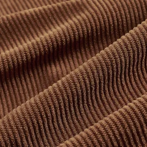 Close-up detail of brown corduroy fabric texture for men's vintage work jacket