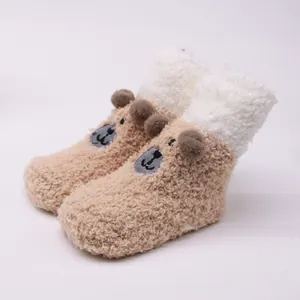 Close-up detail of cute plush bear baby socks featuring soft sherpa texture and 3D ears.