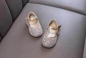 Sparkling gold girls' Mary Jane dress shoes with rhinestone flower detail