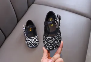 Close-up of elegant black rhinestone princess shoes featuring a bow detail for girls