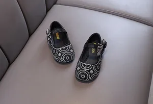 Macro view of black toddler princess shoes with sparkling rhinestones and a side bow